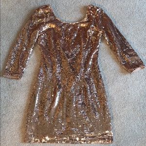 Low back gold sequence dress.